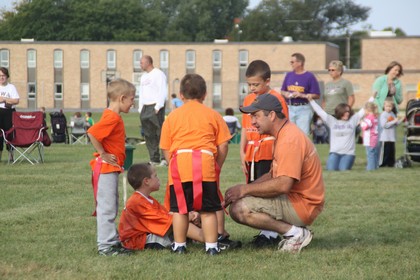 kids talking to coach