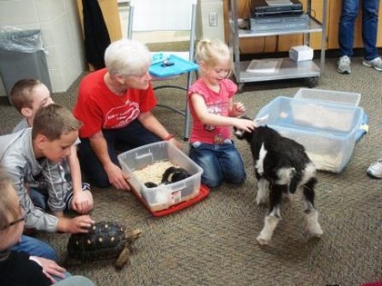 group of kids playing with animal